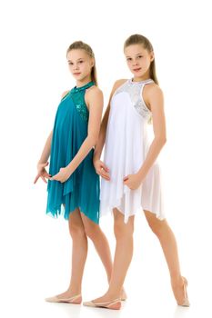 Pretty Graceful Ballet Dancers Performing in Studio, Two Beautiful Twin Sisters Dancing Wearing White and Blue Sport Dresses, Two Teenage Girls Posing in Studio Against White Background