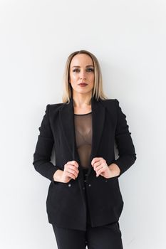 Fashion concept - Portrait of sexy business woman in a suit on white.