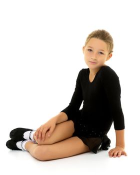 A gymnast girl prepares for the exercise. The concept of childhood and sport, a healthy lifestyle. Isolated on white background.