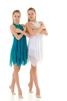 Pretty Gymnasts Performing Rhythmic Gymnastics Exercise, Two Beautiful Teen Sisters Dancing Wearing Sport Dresses, Two Girls Posing in Studio Against White Background