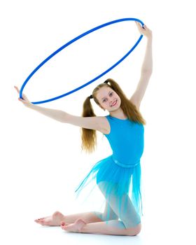 A girl gymnast performs an exercise with a hoop. The concept of gymnastics and fitness. Isolated on white background.