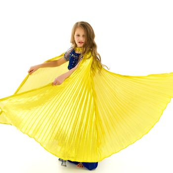 Beautiful Blonde Long Haired Girl Dancing Belly Dance with Wings, Lovely Child in Traditional Blue Decorated Oriental Costume Waving her Yellow Wings in Studio on Isolated White Background