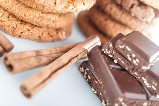 Homemade corded wholegrain cookies with oatmeal, linen and sesame seeds and traditional cookies with chocolate chips and pieces broken chocolate bars with seeds and nuts. Healthy vegan food concept.