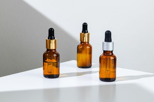 Oily skincare moistrizing brown glass jar with pipette close up