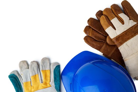 Safety hardhat and work gloves isolated on white background, close up