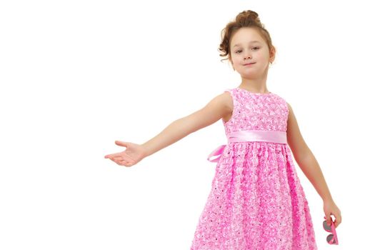 Portrait of a trendy little girl on a white background. The concept of photo for the cover of the magazine, stylish children's clothing. Isolated.
