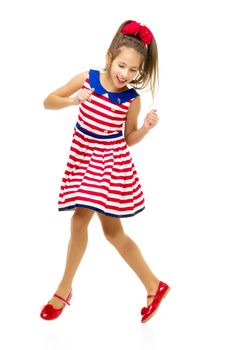 A little girl is jumping and waving her hands. The concept of a happy childhood, outdoor recreation. Isolated on white background.