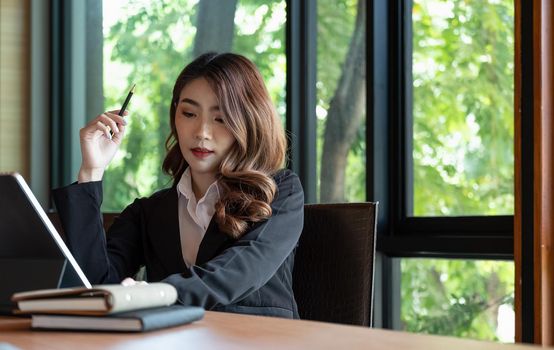 Asian woman working laptop. Business woman busy working on laptop computer at office.