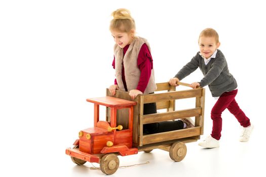 Brother and sister are playing with a toy car. The concept of happy childhood, people, harmonious development of the child in the family. Isolated on white background.