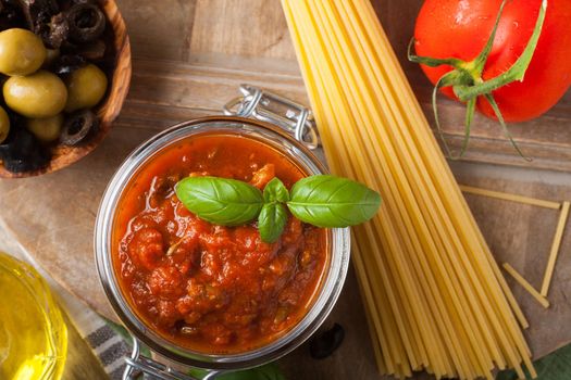 Traditional homemade tomato sauce with spaghetti and ingredients. Italian healthy food background. View from above.