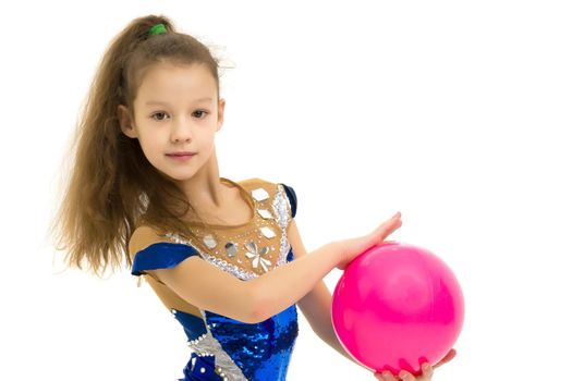 Beautiful little girl gymnast performs exercises with the ball. The concept of children's sports, fitness. Isolated on white background.