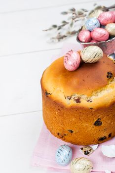 Easter bread and colorful eggs on white background