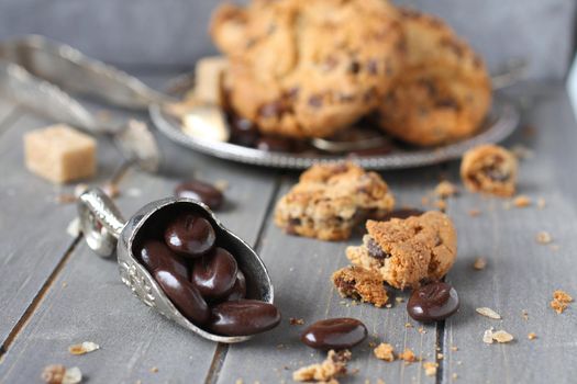 Chocolate candy with chocolate chip cookies on wooden background