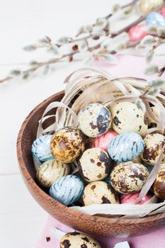 Colorful chocolate easter eggs in wooden bowl - easter composition