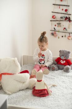 A girl playing in a room with the plush toys