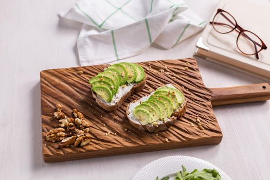 Avocado sandwich on dark rye bread made with fresh sliced avocados from above