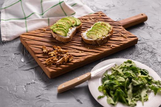 Avocado sandwich on dark rye bread made with fresh sliced avocados from above