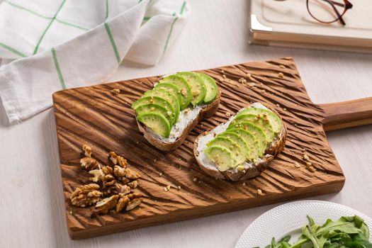 Avocado sandwich on dark rye bread made with fresh sliced avocados from above