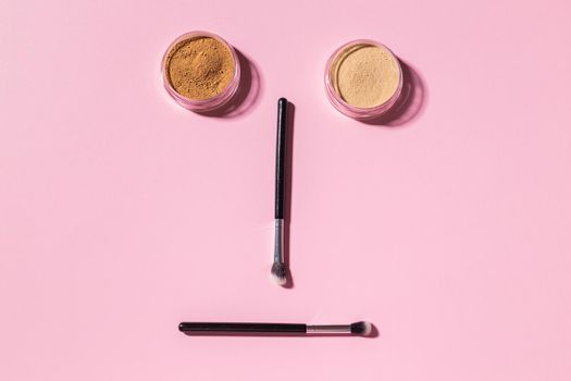 Various make-up brushes on pink background, top view. Cosmetics and beauty