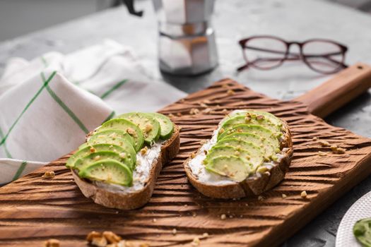 Avocado sandwich on dark rye bread made with fresh sliced avocados from above