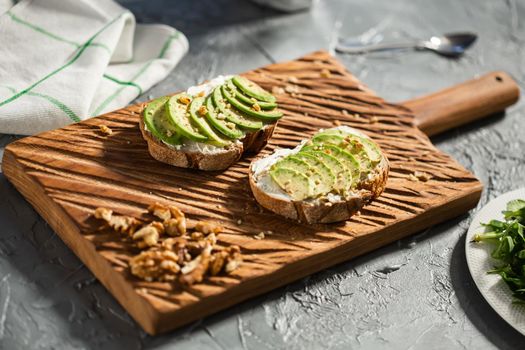 Avocado sandwich on dark rye bread made with fresh sliced avocados from above