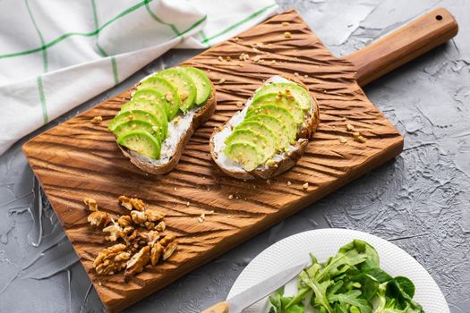 Avocado sandwich on dark rye bread made with fresh sliced avocados from above