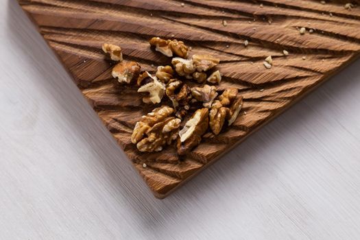 Walnut kernels on rustic board. Concept of healthy food and vegetarianism.