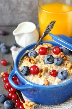 Healthy Tasty Homemade Oatmeal with Berries and glass of juice for Breakfast