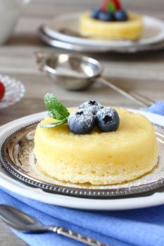 Delicious lemon pudding cake served with berries