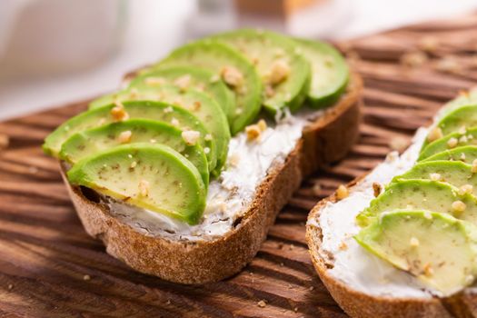 Avocado sandwich on dark rye bread made with fresh sliced avocados from above