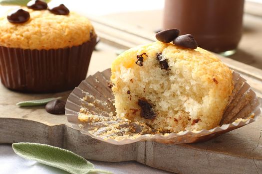 Delicious homemade gluten free muffins with chocolate drops on wooden cutting board