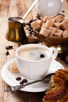 Espresso Coffee cup with Coffee pot, beans sugar sticks and milk jug . Inspirational early morning breakfast.