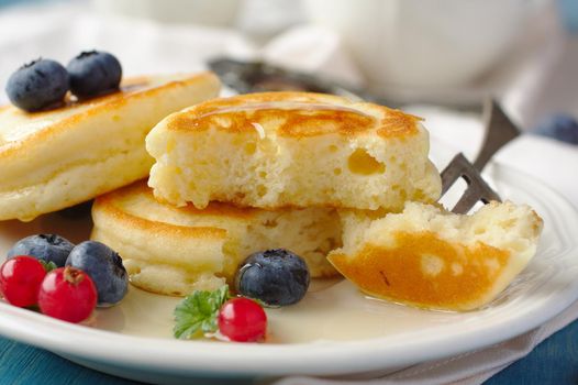 Homemade delicious pancakes with fresh berries and honey