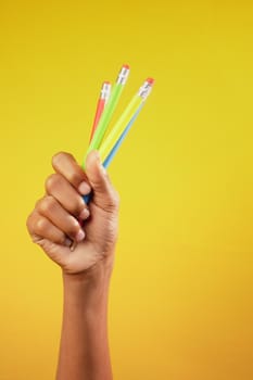 child girl holding many color pencils .