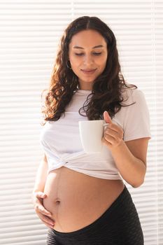 Pregnant woman eating breakfast. Pregnancy and maternity leave.