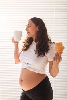 Pregnant woman eating breakfast. Pregnancy and maternity leave.