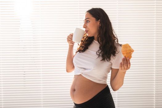 Pregnant woman eating breakfast. Pregnancy and maternity leave.