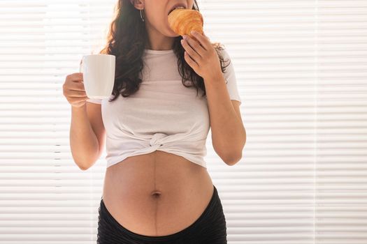Pregnant woman eating breakfast. Pregnancy and maternity leave.
