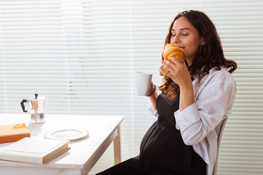 Pregnant woman eating breakfast. Pregnancy and maternity leave.