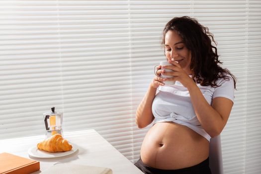 Pregnant woman eating breakfast. Pregnancy and maternity leave.