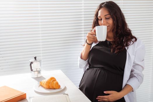 Pregnant woman eating breakfast. Pregnancy and maternity leave.
