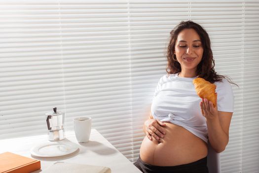 Pregnant woman eating breakfast. Pregnancy and maternity leave.