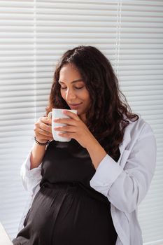 Pregnant woman eating breakfast. Pregnancy and maternity leave.