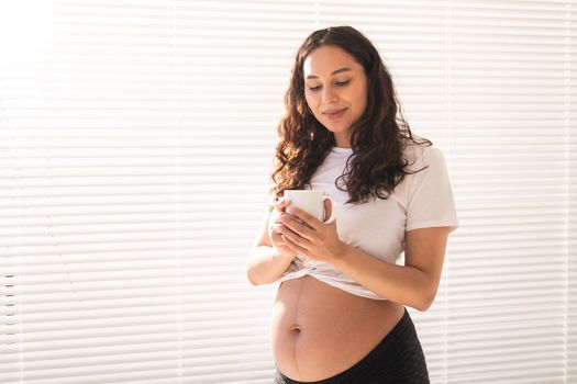 Pregnant woman eating breakfast. Pregnancy and maternity leave.