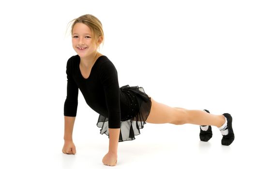 A sweet little gymnast girl performs an acrobatic element on the floor. The concept of sport, healthy lifestyle. Isolated on white background.