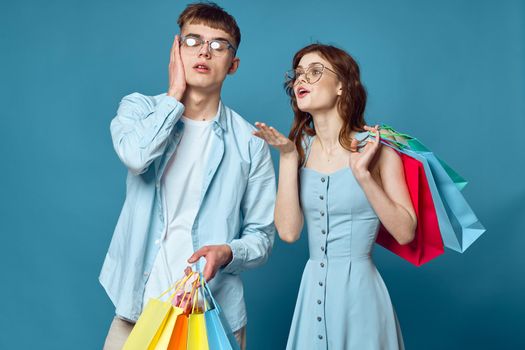 young couple with shopping bags fashion studio. High quality photo