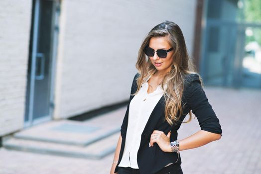 Business woman with glasses and jacket portrait in the city