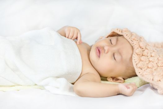 Baby sleeping on bed in the bedroom at home