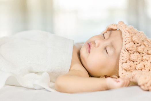 Baby sleeping on bed in the bedroom at home