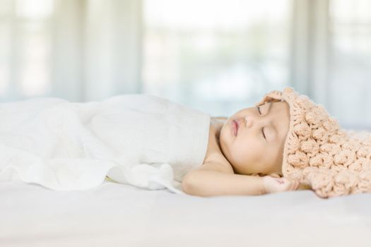 Baby sleeping on bed in the bedroom at home